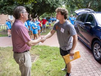 Move In Day 2022 Doug Hicks shaking a student's hand