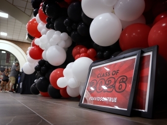 Class of 2026 sign with balloons in background