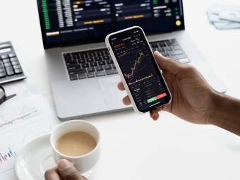 image of person holding iphone with stocks on it
