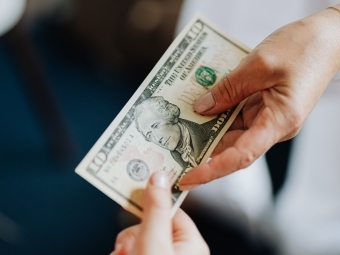 Image of hands passing money