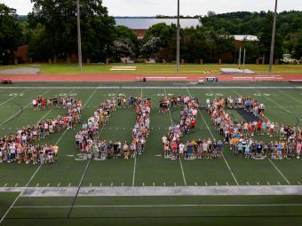 Aerial shot of students on football field forming the numbers "2026"
