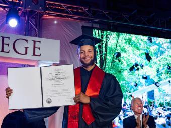 Steph Curry holding diploma