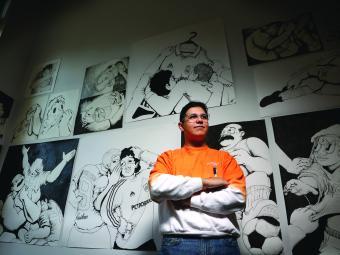 Miguel Donado '23 in front of his artwork