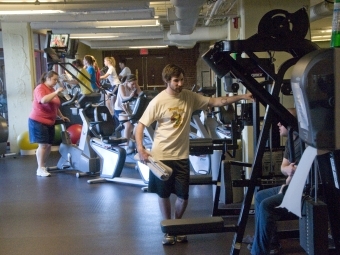 students and staff working out in gym