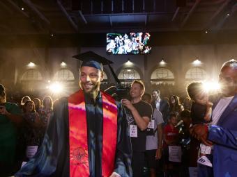 Stephen Curry walking into Belk Arena for his commencement