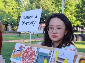 student at table outdoors 