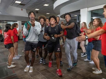 Orientation leaders and cheer team members loudly