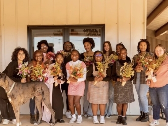 women holding bouquets of flowers