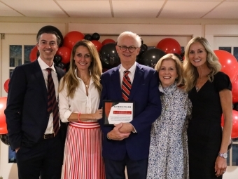 alumni at event with balloons in background