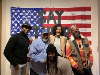 Lori Pitts ’12 with group in front of artwork