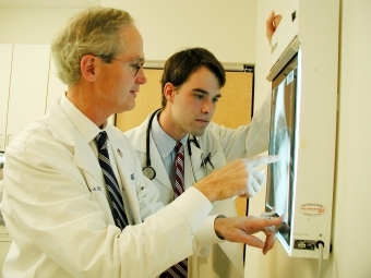 Doctors standing together looking at scan