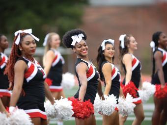 Cheerleading team performing at a football game