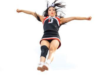 Cheer team member preforming aerial move