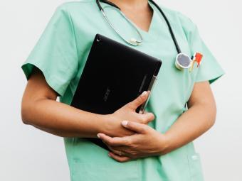 Stock image of nurse carrying documents