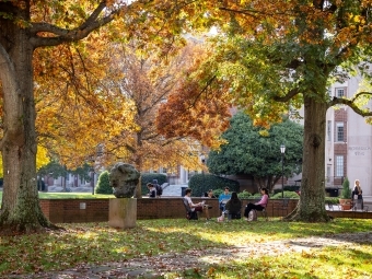 campus scene in front of colorful trees