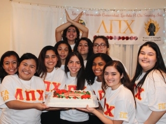 Latinx Sorority Women holding a cake