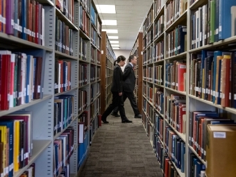 Koji Tomita walking through library