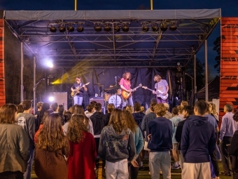 Band, the Stews, performing on stage in front of large group of students