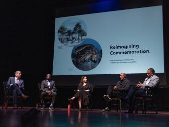Unveiling of the Commemoration Design - Panelists on Stage with Reimagining Commemoration slide in the background