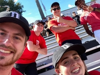 Selfie with students in bleachers at pep band