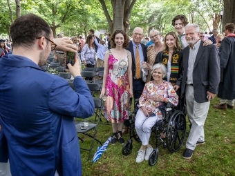 Family poses together for picture during graduation celebration