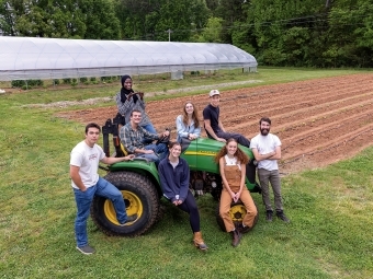 Students seated on a tractor