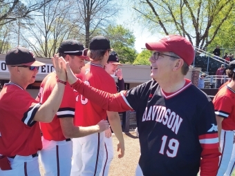 President Douglas Hicks hive fiving baseball player Tyler Douglas