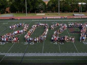 Students on football field spell out "2027"