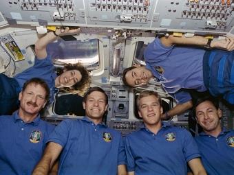 On the Space Shuttle Atlantis' flight deck, the six crew members pose for the traditional inflight crew portrait