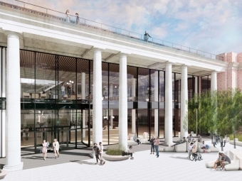 a modern looking library with white columns and green trees