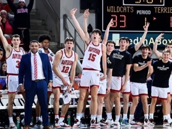 Basketball team and coaches celebrating