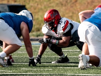 Football in action with Malik McDaniel with Davidson teammates