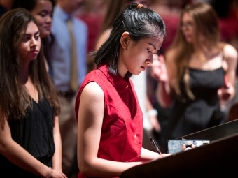 Student signing the Honor Code during ceremony