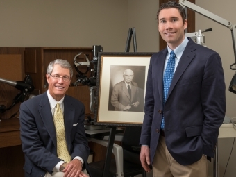 John Saunders ’71, M.D., with portrait of his father, Joseph Saunders, M.D., and son and fellow Wildcat Justin Saunders ’02, M.D.