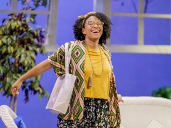 a young woman wearing bright clothes while in a theatre production