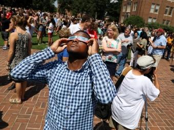 community gathers at the 2017 total solar eclipse wearing protective eye gear