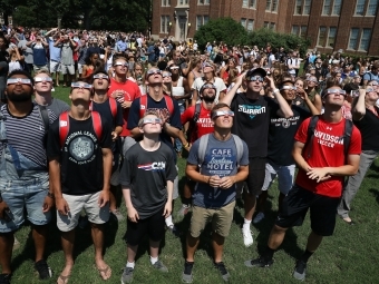 Davidson community on the front lawn observing w safety glasses the 2017 Davidson Eclipse