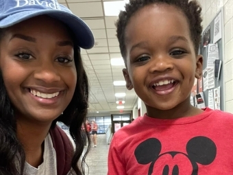 Morgan Bell Kee ’12 smiling with child