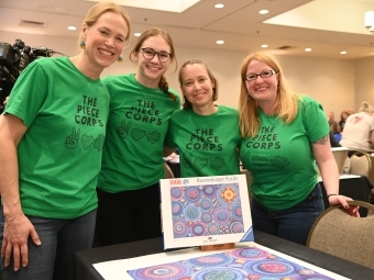 Becca Taylor ’06 and Piece Corps Champs surround a mandala puzzle