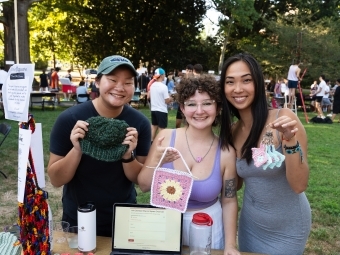 Students holding crafts at activities fair
