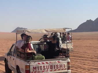 a truck filled with people in a desert