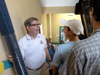 Douglas Hicks moving a carpet in move-in day