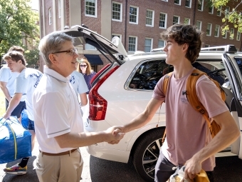 Dougs Hicks shaking hands with new move-in