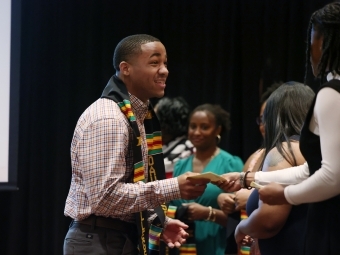 a group of young Black students embrace