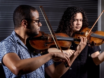 Marcus Pyle and Anthony Strouse playing violins together