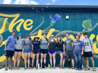 Sustainability Scholars group stands outside against a mural
