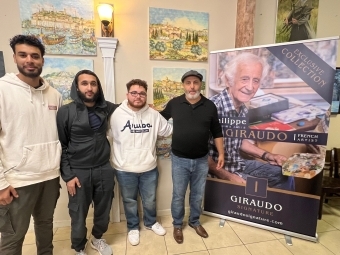 a group of students with an older artist standing together
