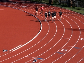 Lisa and Jeff Case Track & Field Complex team running on the track