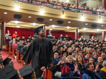 student walking down the aisle at Convocation 2025