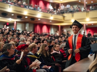 Student walking down the aisle during Convocation 2025